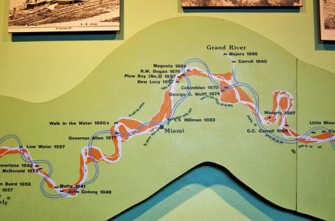 This interpretive graphic shows the course of the Missouri River (light color) before man-made and nature's changes altered the river's course. The double, darker blue lines show the present course. The panel is located in the Steamship Arabia museum in Kansas City, MO (2007). Viewing the original course, one can better speculate where McIlwaine's Bend might have been.